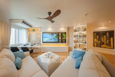 Luxurious living room with modern decor and large TV, perfect for relaxation.