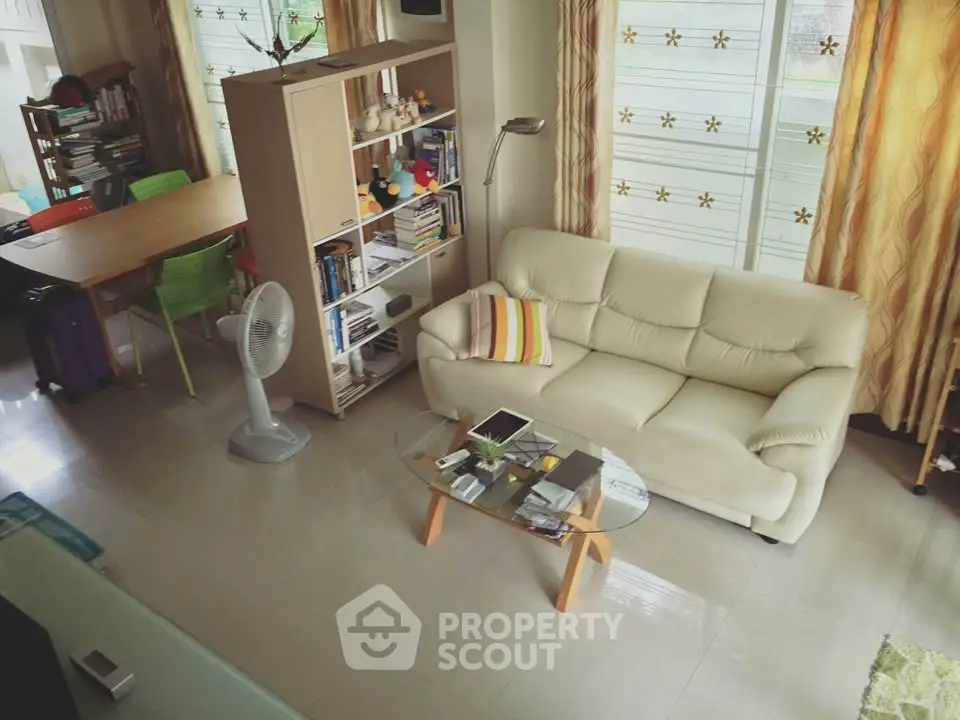 Spacious living room with modern furniture and natural light, perfect for family gatherings.