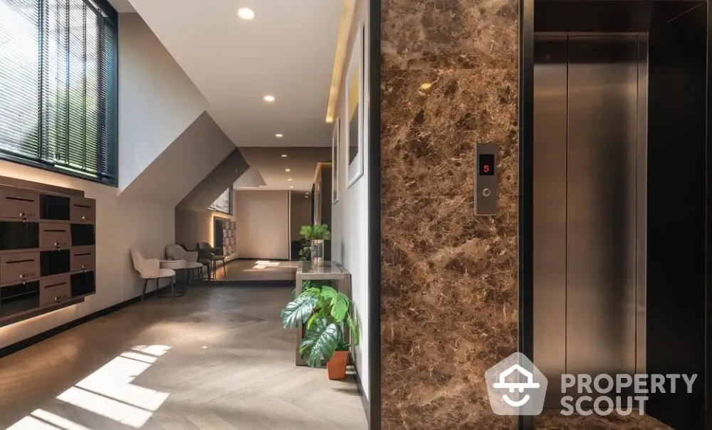 Luxurious modern building entrance with elegant elevator and stylish decor