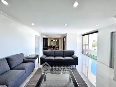 Spacious modern living room with sleek furniture and abundant natural light.