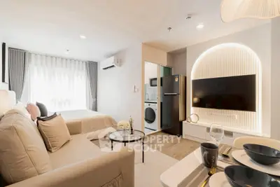 Modern studio apartment with open layout, featuring a cozy living area, stylish kitchen, and elegant bedroom.