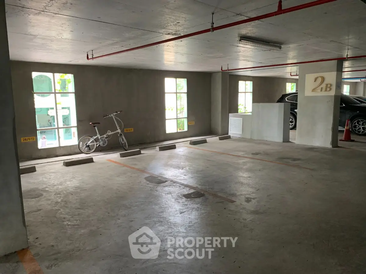 Spacious indoor parking area with natural light and bicycle storage.