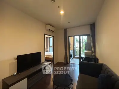 Modern living room with sleek furniture and balcony view in a stylish apartment.