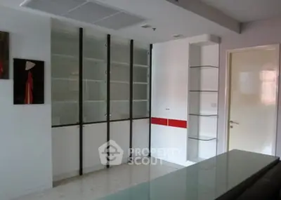 Modern living room with sleek built-in cabinets and minimalist decor.