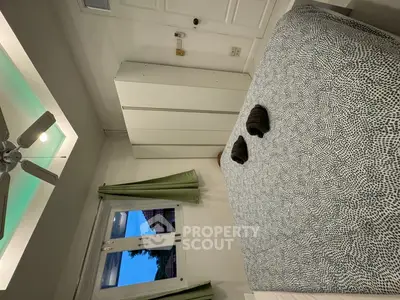 Cozy bedroom with modern decor and ambient lighting, featuring a large bed and wardrobe.