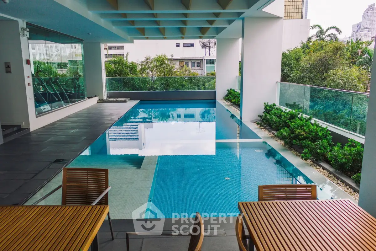 Luxurious rooftop pool with modern design and city view, perfect for relaxation and entertainment.