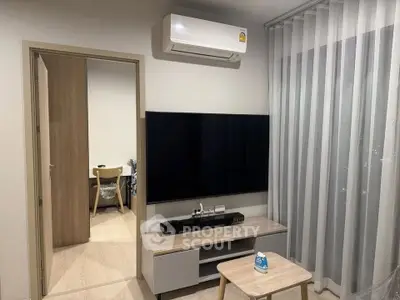 Modern living room with sleek TV setup and air conditioning, perfect for cozy relaxation.