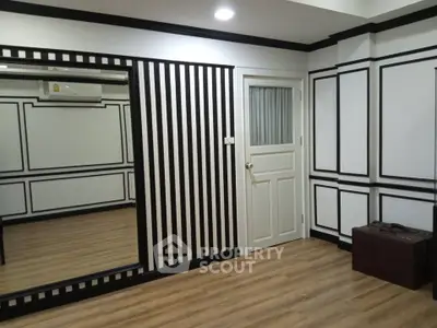 Stylish modern interior with striped walls and wood flooring