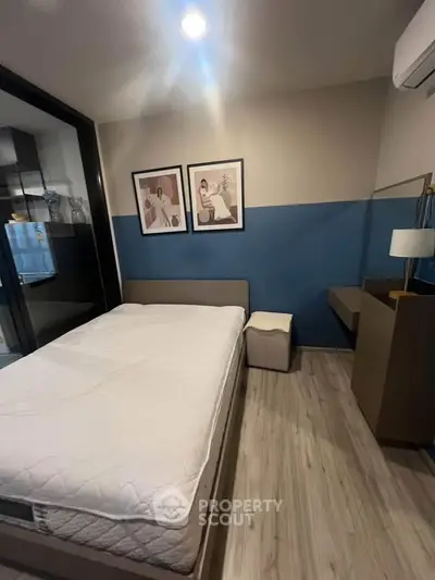 Modern bedroom with stylish decor and cozy ambiance, featuring a comfortable bed and elegant wall art.
