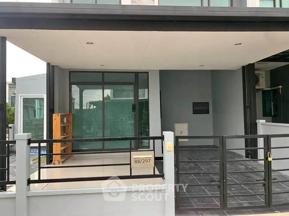 Modern townhouse exterior with sleek design and spacious driveway