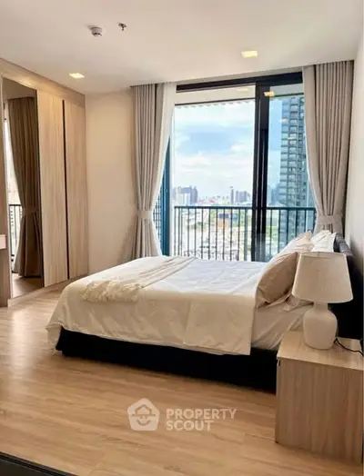 Spacious bedroom with city view and modern decor in high-rise apartment