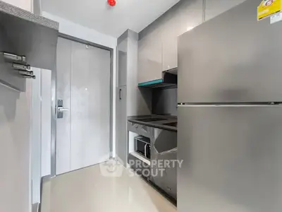 Modern compact kitchen with sleek appliances and minimalist design