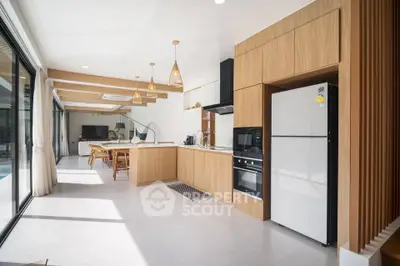 Modern open-layout kitchen with wooden cabinetry and sleek appliances