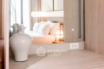 Modern bedroom with elegant decor and soft lighting, featuring a stylish vase and cozy ambiance.