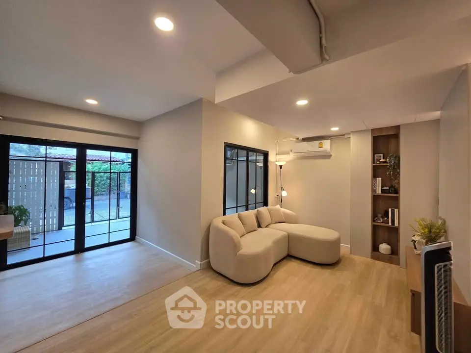 Spacious modern living room with elegant decor and large windows for natural light.