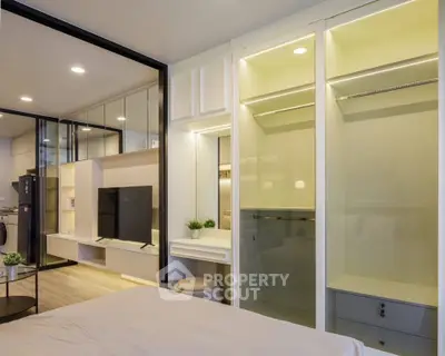 Modern bedroom with built-in closet and sleek TV unit