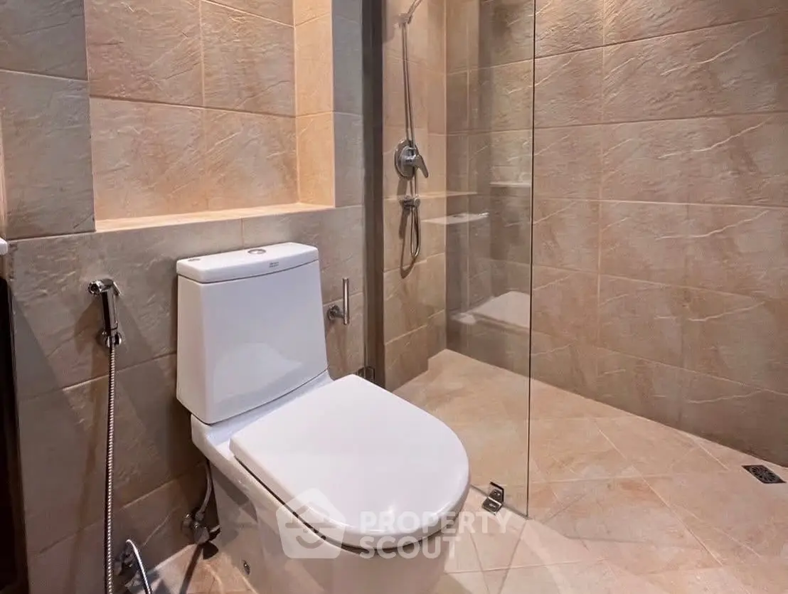 Modern bathroom with glass shower and sleek toilet design