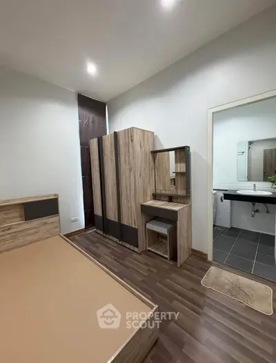 Modern bedroom with wooden furniture and ensuite bathroom