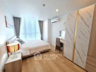 Modern bedroom with stylish decor and ample natural light