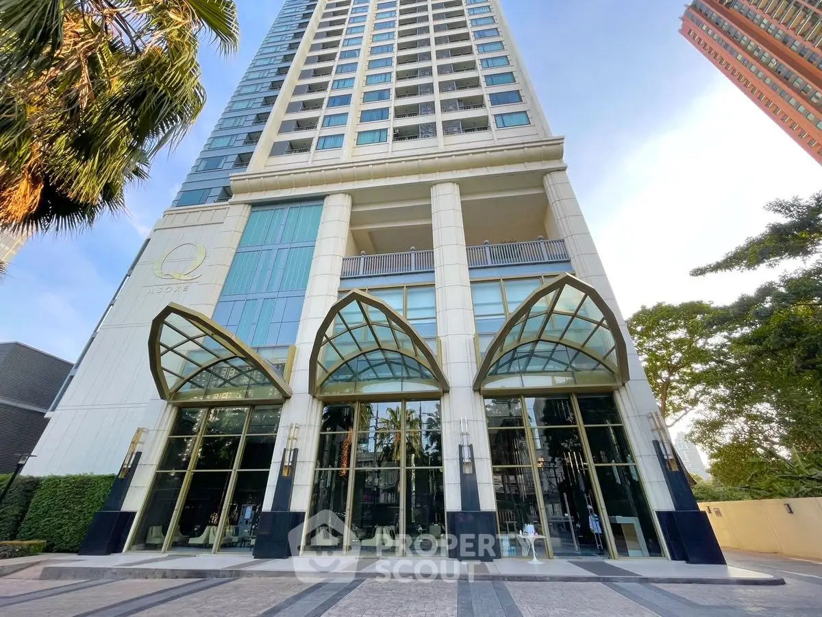 Stunning high-rise building entrance with modern architectural design and glass canopy, perfect for urban living.