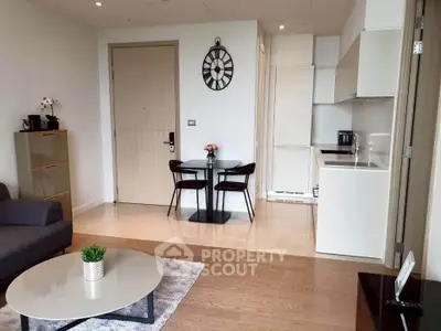 Modern living room with stylish decor and compact kitchen area