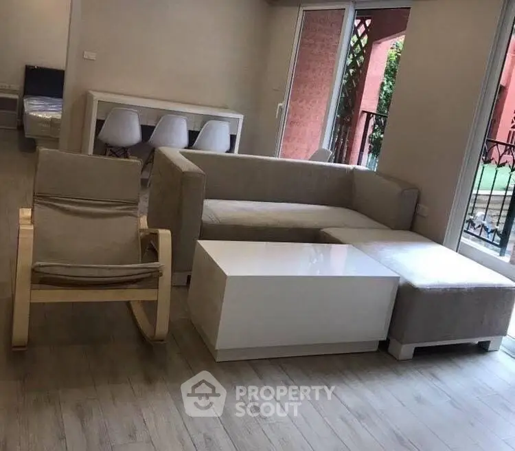 Modern living room with stylish furniture and balcony view