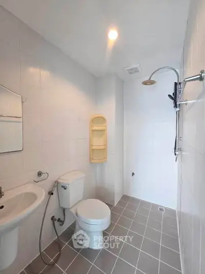 Modern bathroom with sleek fixtures and spacious shower area in a contemporary home.