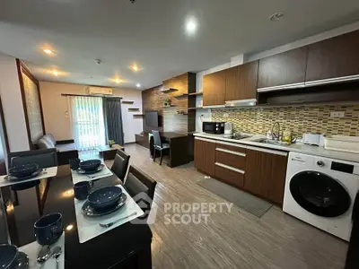Modern open-layout kitchen and living area with stylish decor and appliances.