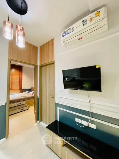 Modern living room with wall-mounted TV and stylish lighting