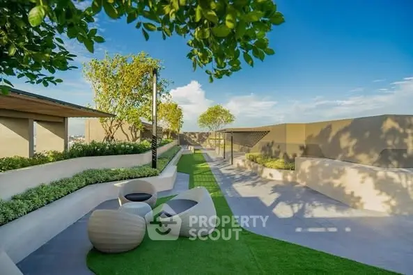 Luxurious rooftop garden with modern seating and lush greenery under a clear blue sky.
