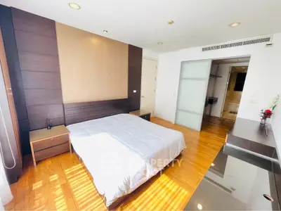 Spacious bedroom with modern design and wooden flooring