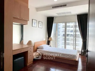 Modern bedroom with city view and elegant wooden furniture