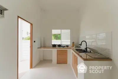 Modern minimalist kitchen with open layout and natural light