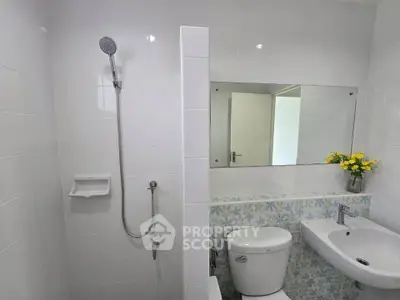 Modern bathroom with sleek fixtures and floral accents, perfect for a refreshing start to your day.