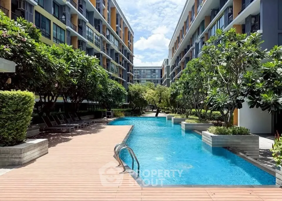 Luxurious condominium with stunning pool and lush greenery, perfect for relaxation and modern living.