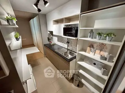 Modern kitchen with sleek cabinetry and built-in microwave, featuring open shelving and stylish decor.