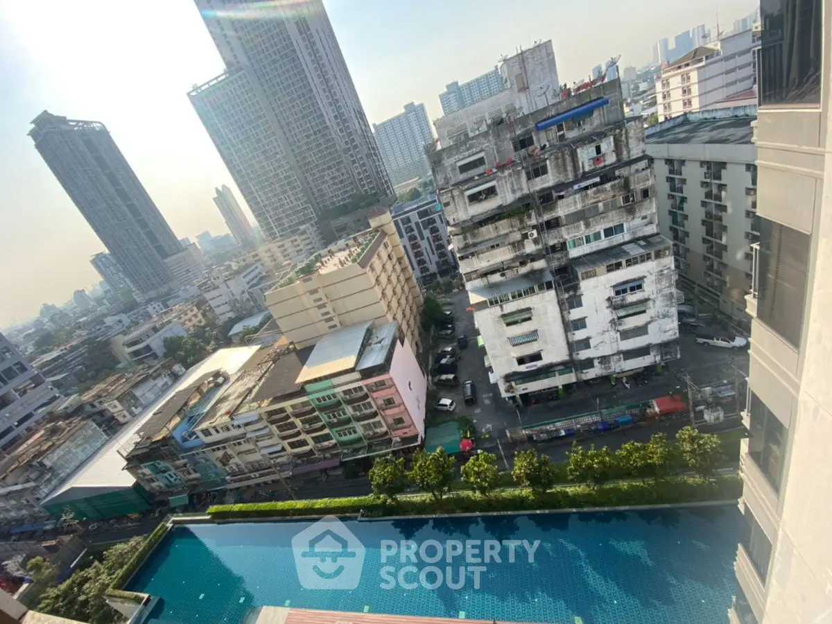 Stunning urban view with high-rise buildings and a serene pool in the foreground.