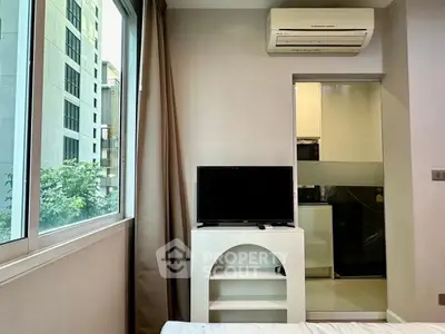 Modern bedroom with large window and air conditioning in urban apartment