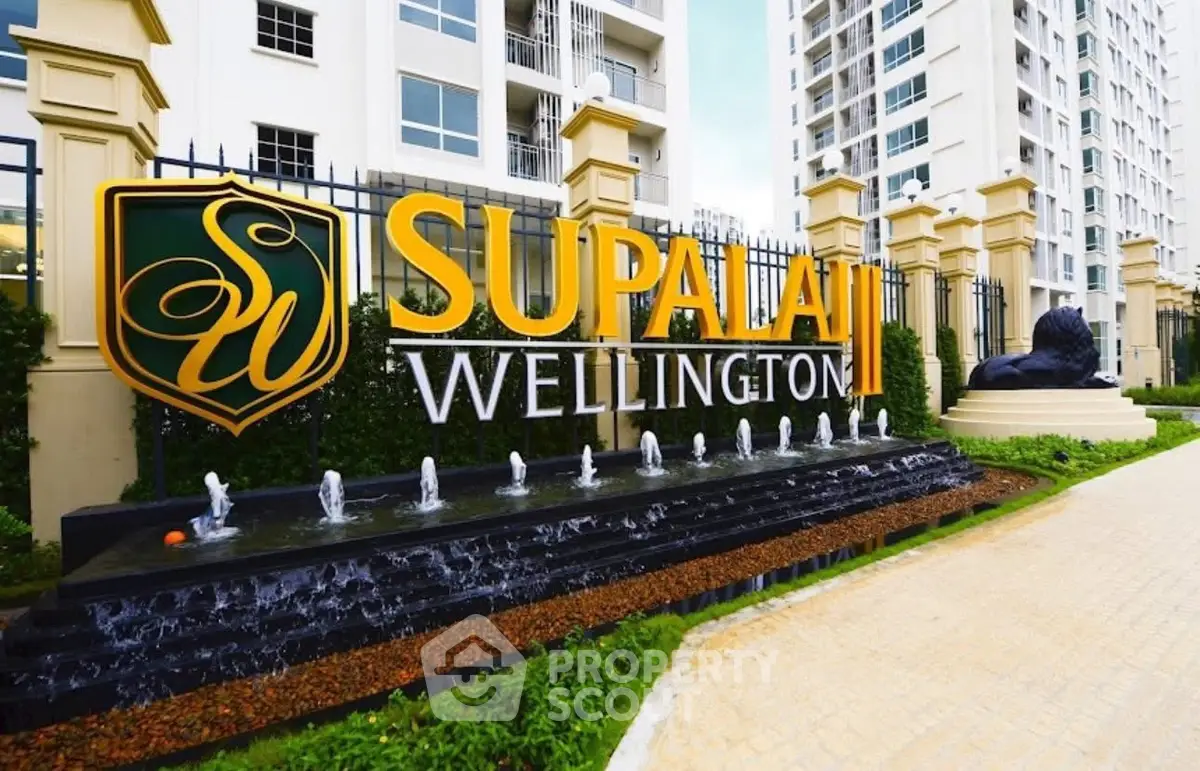 Elegant entrance of Supalai Wellington with modern architecture and water feature.