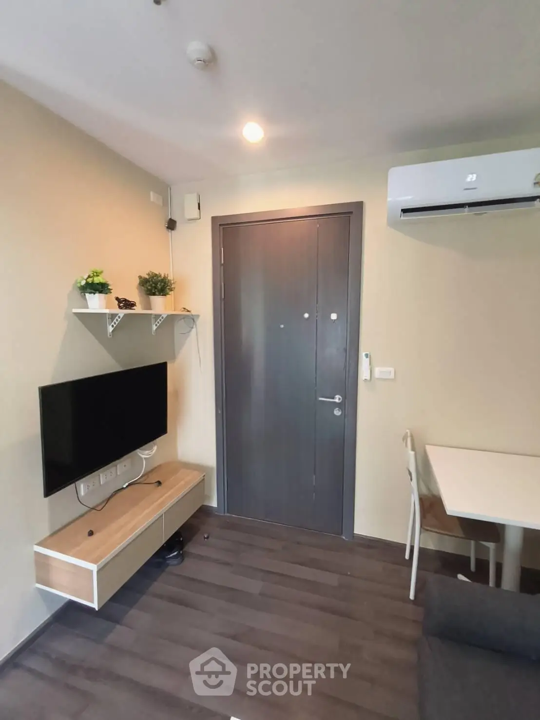 Modern apartment interior with sleek furniture and air conditioning, showcasing a cozy living space.