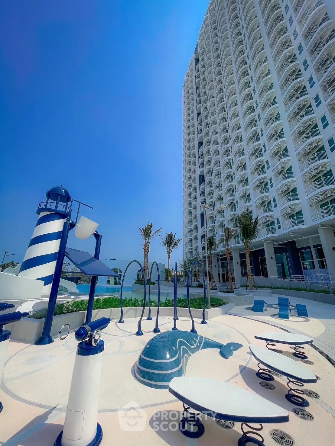 Luxurious high-rise building with modern outdoor playground and stunning architecture.