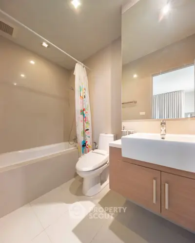 Modern bathroom with sleek fixtures and bathtub in contemporary apartment.