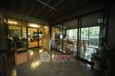 Spacious modern office space with glass walls and garden view