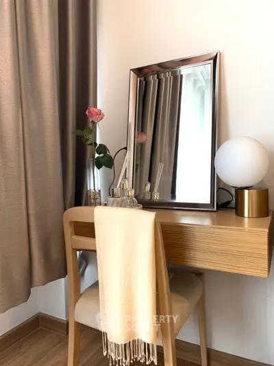 Elegant bedroom vanity with mirror, lamp, and rose decor for a stylish touch.