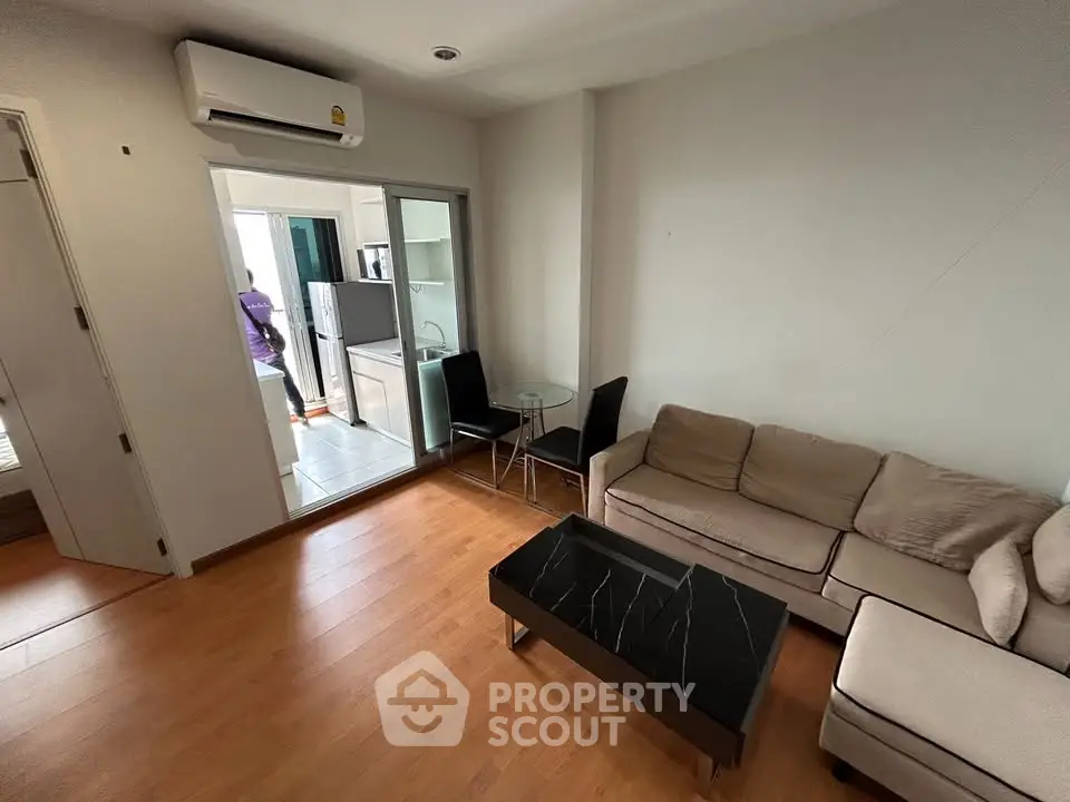 Modern living room with cozy sofa, sleek coffee table, and air conditioning in a stylish apartment.