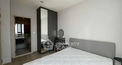 Modern bedroom with ensuite bathroom and sleek furniture design.