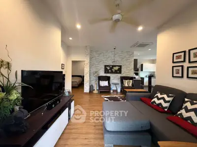 Stylish living room with modern decor and open layout, featuring cozy seating and elegant lighting.