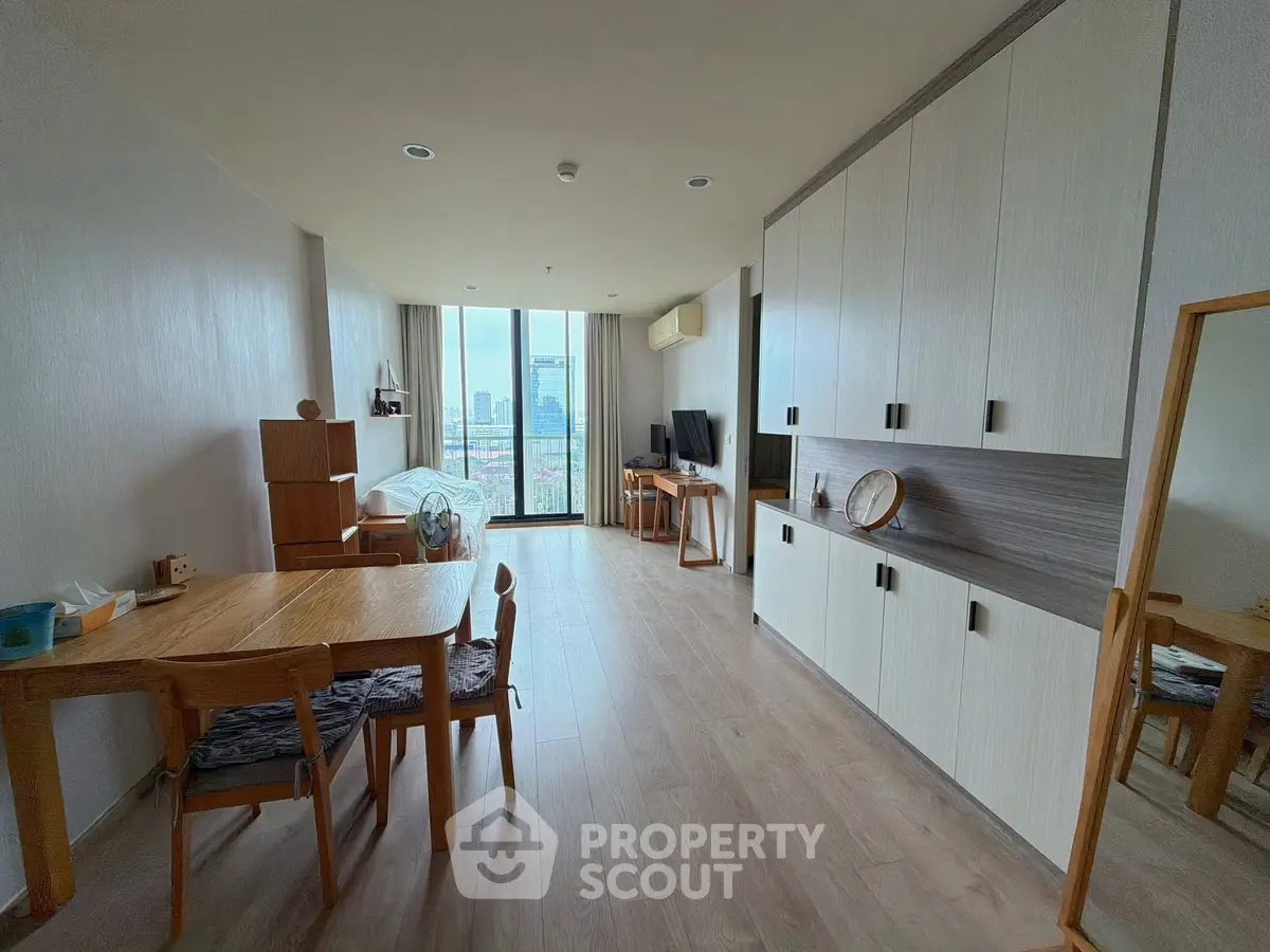 Spacious modern living room with city view and stylish wooden furniture