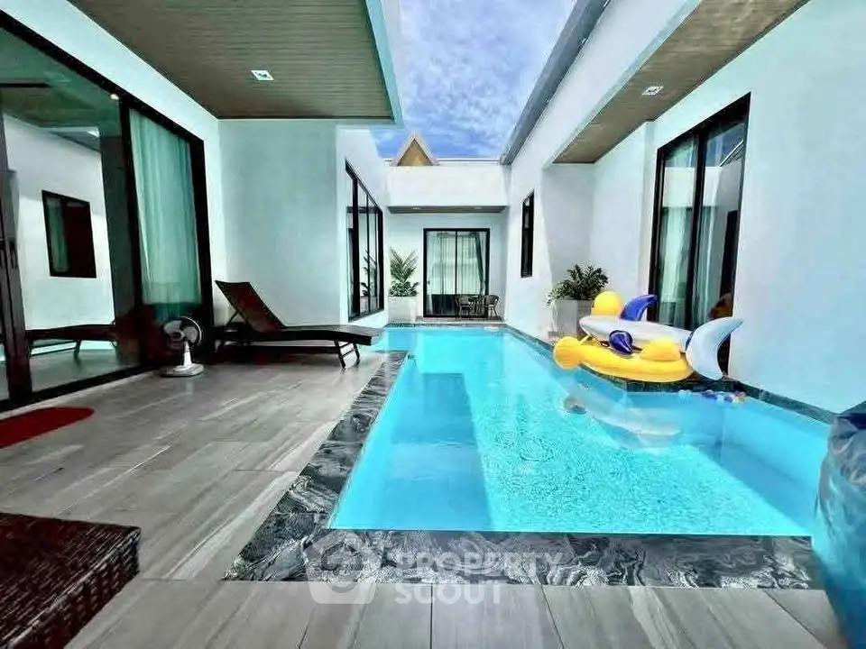 Luxurious modern villa with private pool and stylish outdoor seating area, perfect for relaxation.