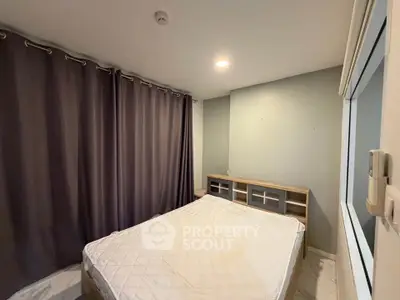 Cozy bedroom with modern design and ample natural light, featuring elegant curtains and a comfortable bed.